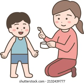 Mom applying ointment to her child