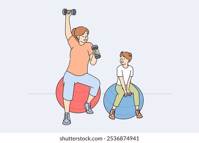 Mom and daughter do fitness sitting on fitballs and lifting dumbbells to improve health. Woman sets example for child, wanting to teach girl to regularly engage in fitness or sports.