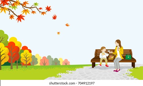 Mom and daughter picnic in the autumn park