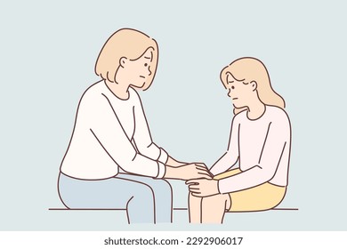 Mom holds hand of sad teenager daughter helps to get rid stress and consoles after quarrel with friends. Caring woman giving support to daughter suffering from depression due to bad grades in school