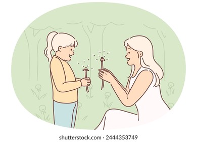 Mom and little daughter are holding dandelions, rejoicing at onset of spring and good hot weather. Caring woman teaches teenager girl with dandelions to love nature and take care of environment