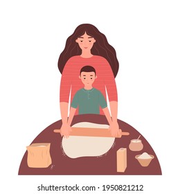 Mom and little son roll out the dough at the kitchen table and have a good time together. A woman and a boy cook dinner. The concept of motherhood, family and friendship