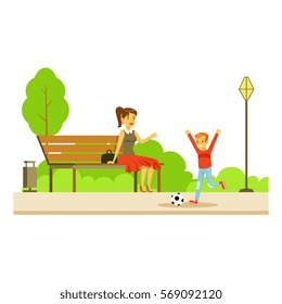 Mom Sitting On The Bench Wathing Her Son Playing Football, Part Of People In The Park Activities Series