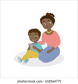 Mom teaches the kid how to use the tablet.