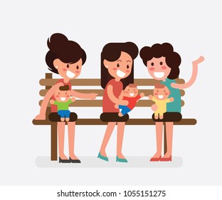 Moms sitting on a bench in the park with their newborn babies