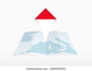 Monaco is depicted on a folded paper map and pinned location marker with flag of Monaco. Folded vector map.