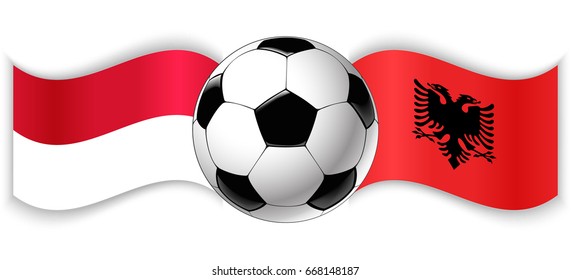 Monegasque and Albanian wavy flags with football ball. Monaco combined with Albania isolated on white. Football match or international sport competition concept.