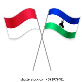 Monegasque and Basotho crossed flags. Monaco combined with Lesotho isolated on white. Language learning, international business or travel concept.