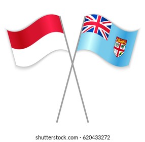 Monegasque and Fijian crossed flags. Monaco combined with Fiji isolated on white. Language learning, international business or travel concept.