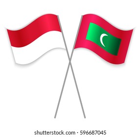 Monegasque and Maldivian crossed flags. Monaco combined with Maldives isolated on white. Language learning, international business or travel concept.