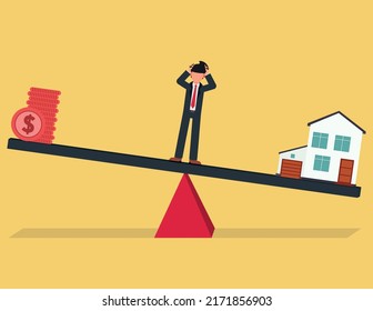 Money And House, Business Deficit Concept. Stressful Businessman Standing On The Unbalanced Seesaw Between Income And Housing Expenses