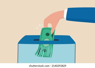 Money shred bad investment, scam or fraud causing losing money, mistake or financial failure spending concept, businessman hand feed banknote money into shredder to destroy losing all his wealth.