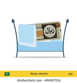 Money sleeping in the bed. Saudi Arabian riyal banknote. 