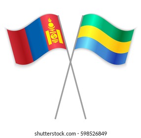 Mongolian and Gabonese crossed flags. Mongolia combined with Gabon isolated on white. Language learning, international business or travel concept.