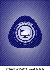 monitor icon inside badge with denim texture