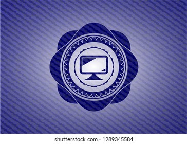 monitor icon inside badge with denim background