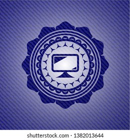 monitor icon inside badge with denim background