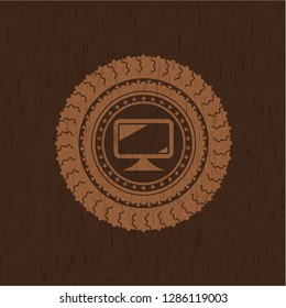 monitor icon inside badge with wood background