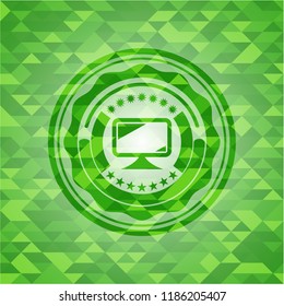 monitor icon inside green emblem with mosaic background