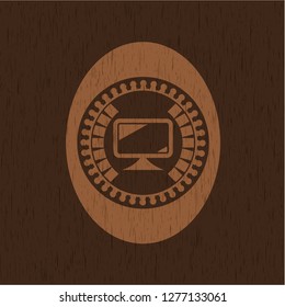 monitor icon inside realistic wood emblem