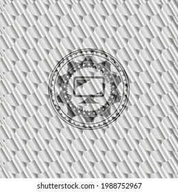 monitor icon inside shiny silver badge. Scales pattern. Vector Illustration. Detailed. 