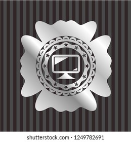 monitor icon inside silver emblem or badge