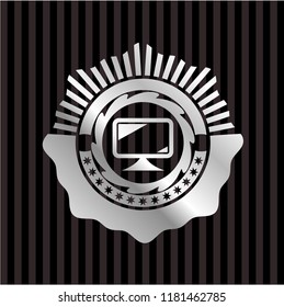 monitor icon inside silvery emblem