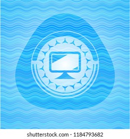 monitor icon inside sky blue water wave style badge.