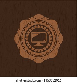 monitor icon inside wood badge or emblem