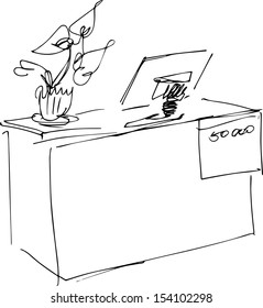 a monitor image on a table near a flower