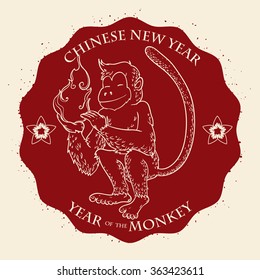 Monkey holding fire for Chinese New Year in red stamp.