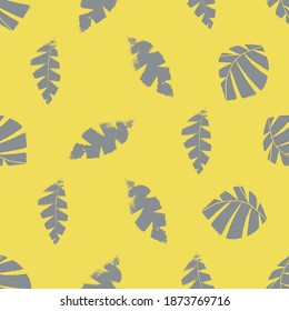 Mono print style scattered leaves seamless vector pattern background. Textured cut out grey foliage on yellow backdrop. Hand crafted painterly design. All over print for fall products