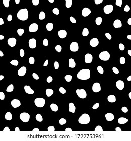 Monochromatic black and white hand drawn polka dot circle motif. Irregular layout, random composition, cool op art design style. Elegant stylish timeless vector. Classic seamless pattern with a twist.