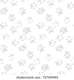 Monochrome background from the prints of real dog's paws, seamless pattern with dirty Labrador traces, like a footprint on snow. Vector gray scale illustration, isolated, sample in file.