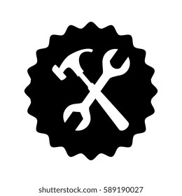 monochrome circular emblem with hammer and wrench