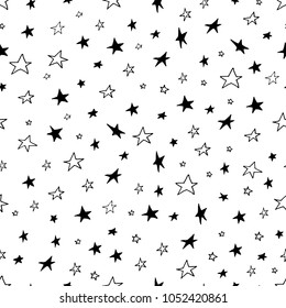 Monochrome hand drawn seamless pattern with black and white doodle stars confetti background for nursery kids baby desighn cards clothes interior
