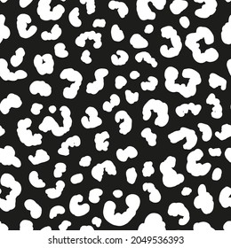 Monochrome leopard skin seamless repeat pattern. Random placed, vector spots animal all over print on black background.