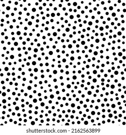 Monochrome pattern of black dots of different shapes on a white background