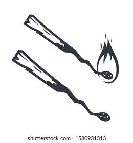 Monochrome silhouette of a burning match with flame