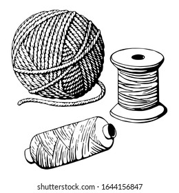 Monochrome vintage balls and spools of thread on white background.