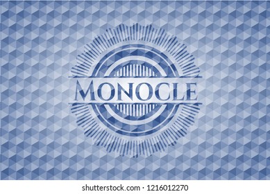 Monocle blue badge with geometric pattern.