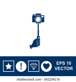 Monopod camera with hand vector icon.