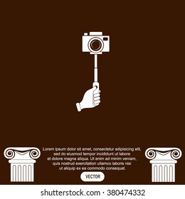 Monopod camera with hand vector icon.