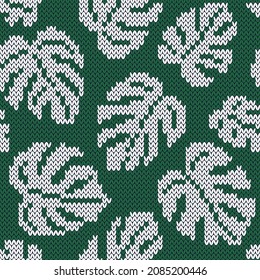 Monstera white leaves on  emerald background. Jacquard knitted seamless pattern. Vector illustration.