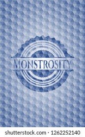 Monstrosity blue badge with geometric background.