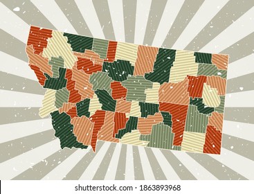 Montana vintage map. Grunge poster with map of the US state in retro color palette. Shape of Montana with sunburst rays background. Vector illustration.