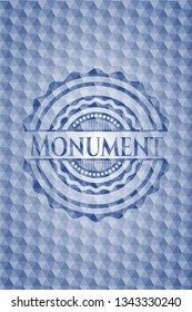Monument blue badge with geometric background.