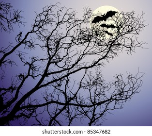 The moon behind tree branches and bats