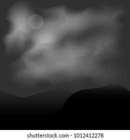 Moon in the clouds on a dark background in the mountains