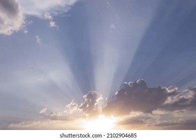 Morning. Sunrise. The sun's rays make their way from behind the clouds.